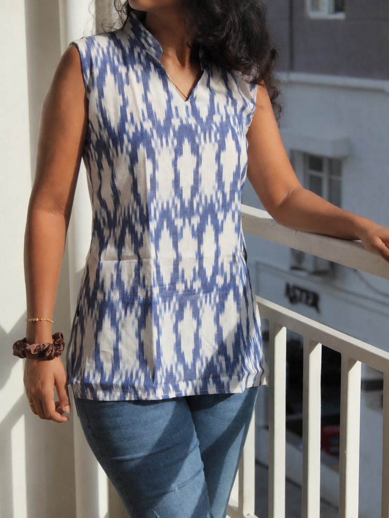 Vanya in Blue — indigo ikat cotton tunic worn with jeans, front view