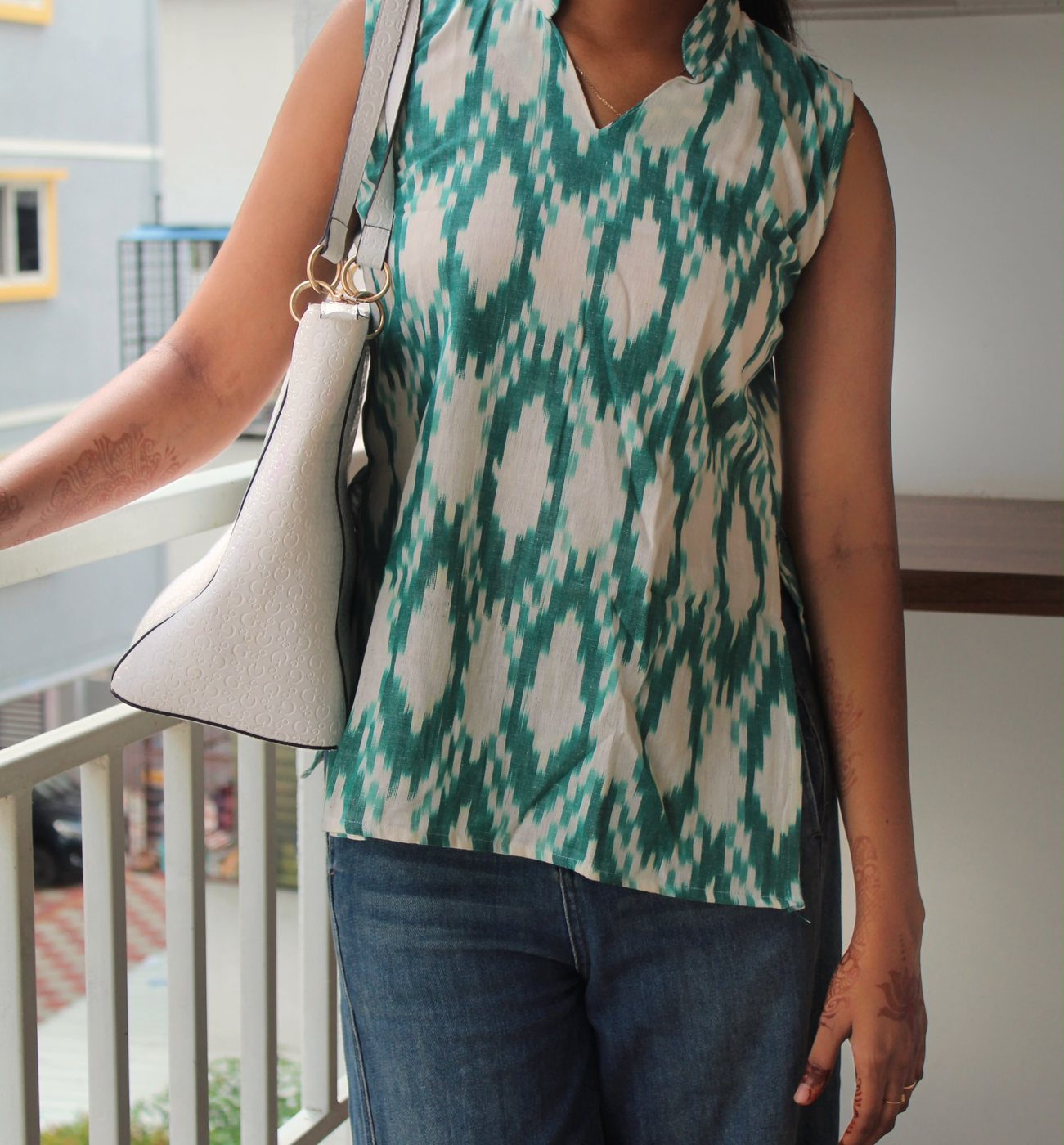 Vanya in Teal — front view showing the stand collar and V opening